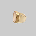 Two-toned ring with gold and silver on a beige background