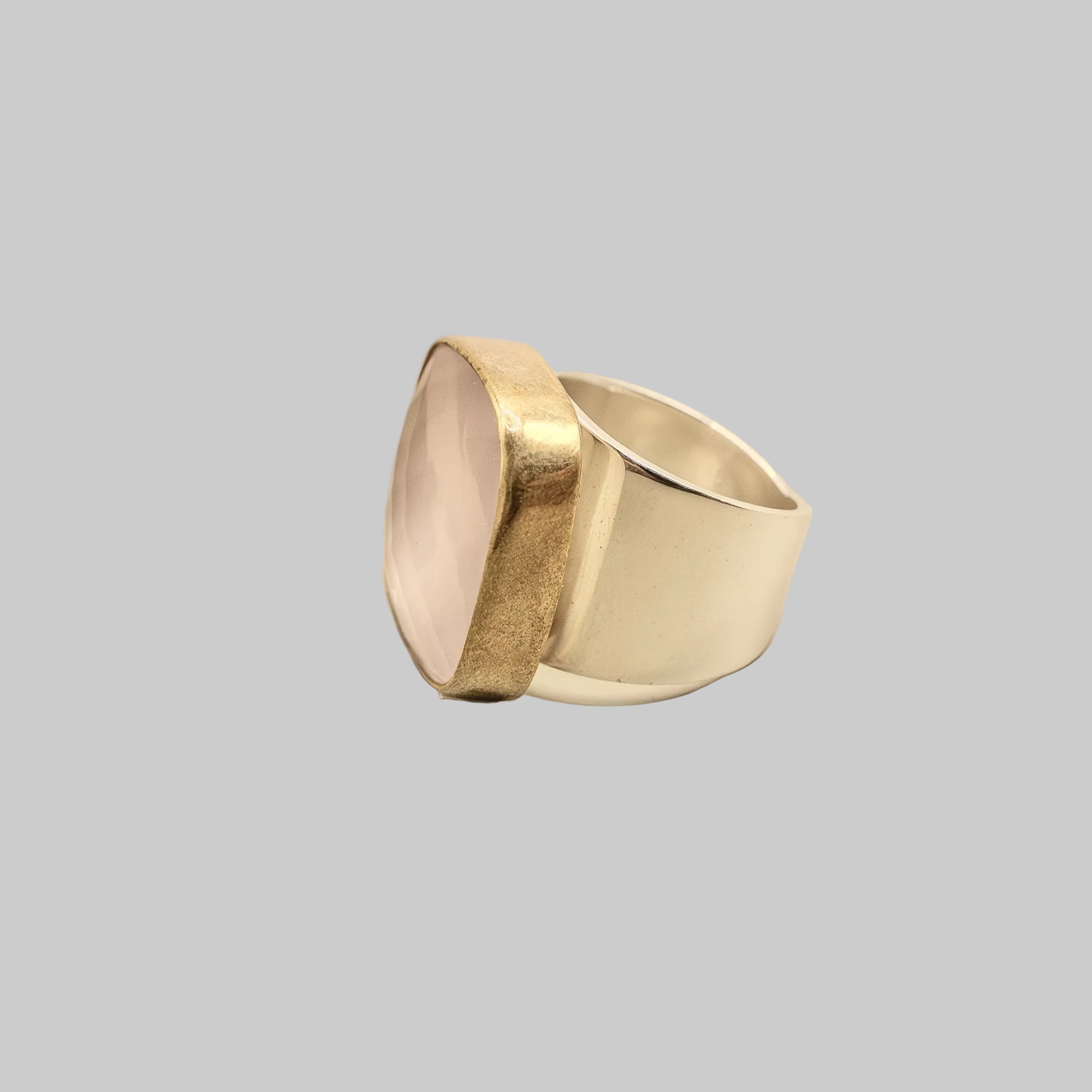 Two-toned ring with gold and silver on a beige background
