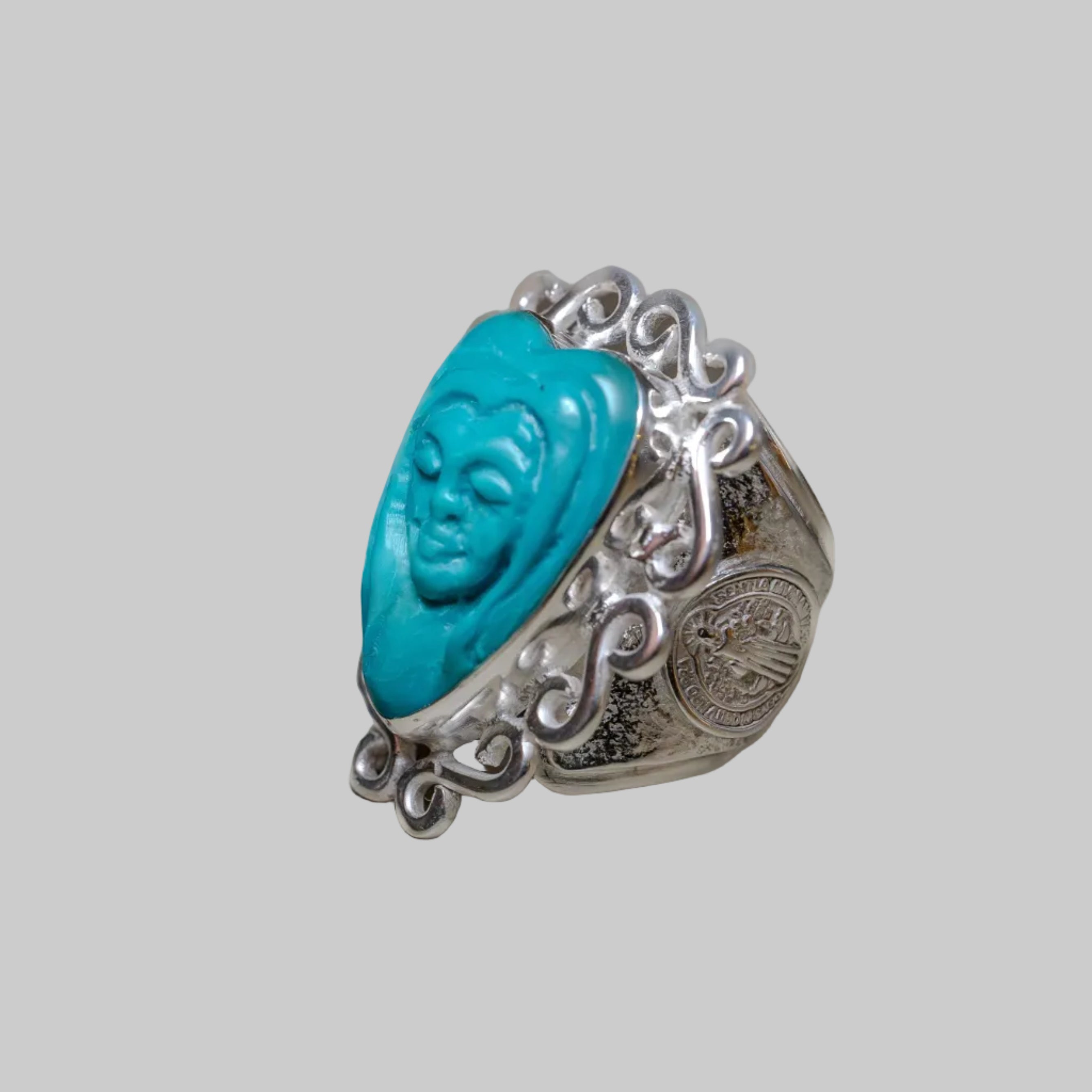 Silver ring with turquoise stone on a beige background