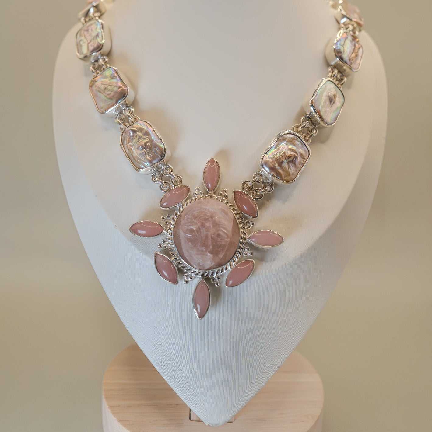 Necklace with pink and silver beads on a white mannequin bust.