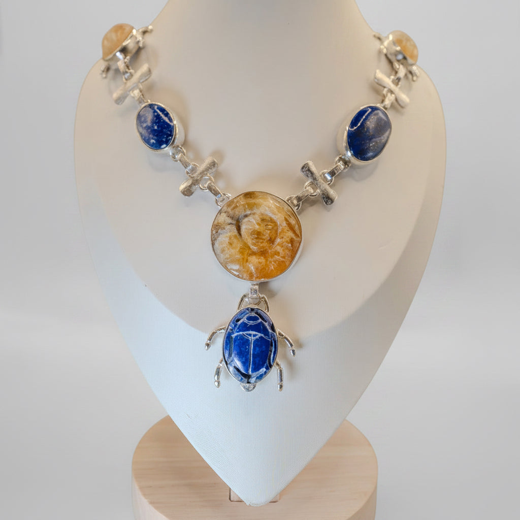 Necklace with blue and yellow stones on a white mannequin bust against a plain background
