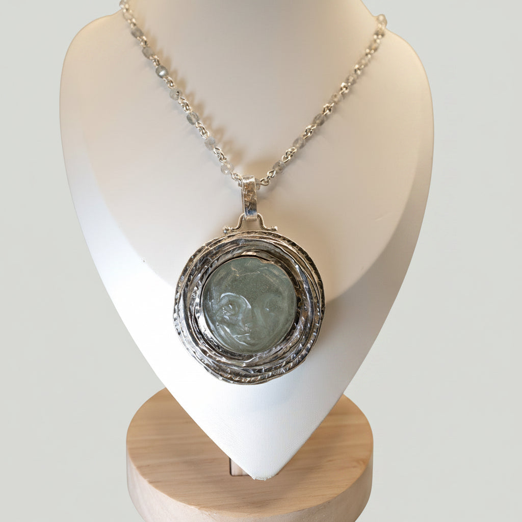 Necklace with a pendant on a white mannequin bust against a beige background