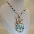 Necklace with a pendant on a mannequin bust against a plain background