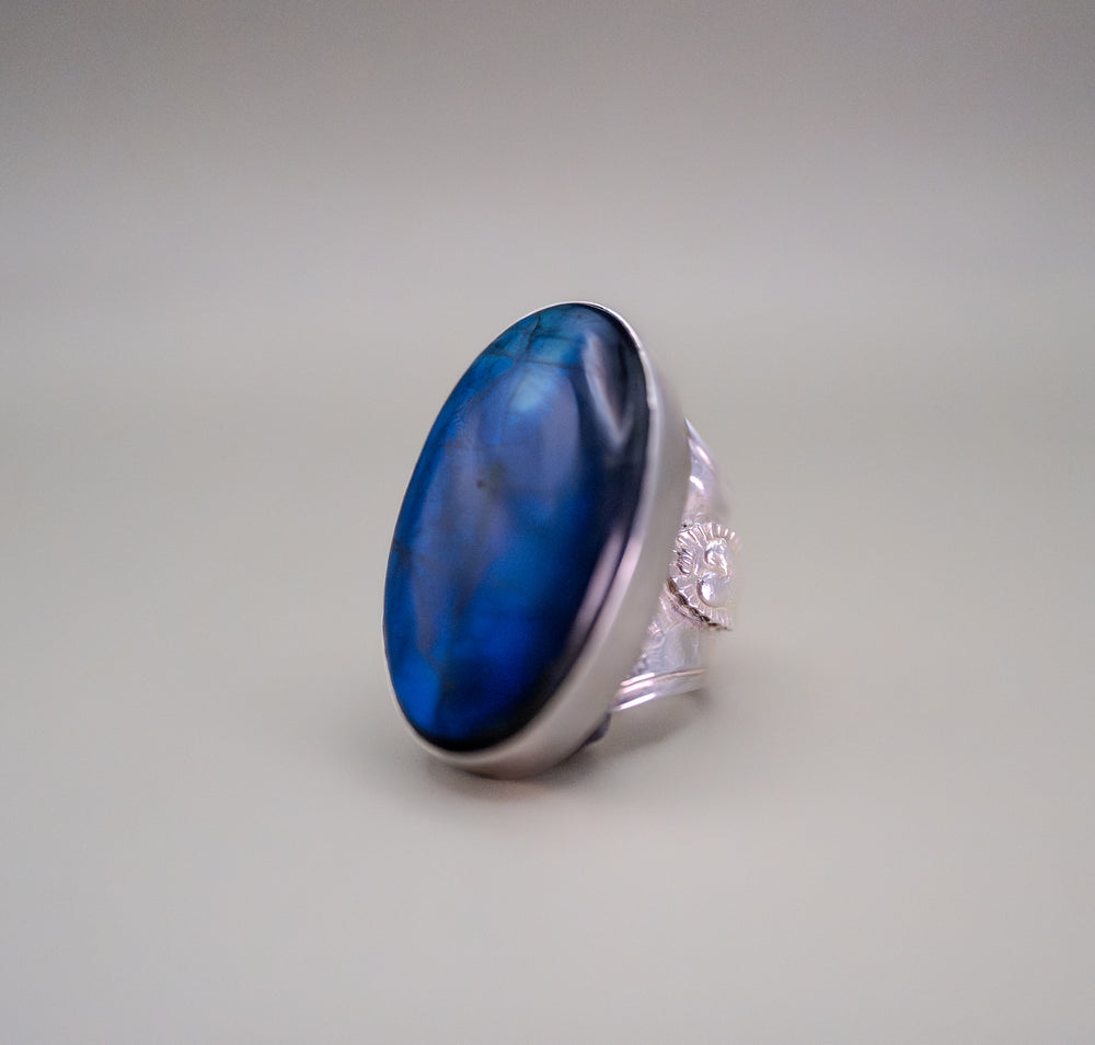 Ring with a blue stone on a gray background