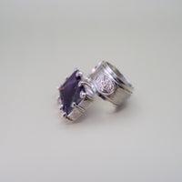 Silver rings with gemstones on a light gray background