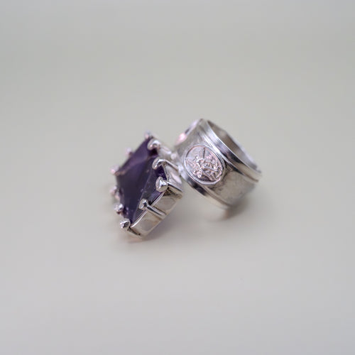Silver rings with gemstones on a light gray background